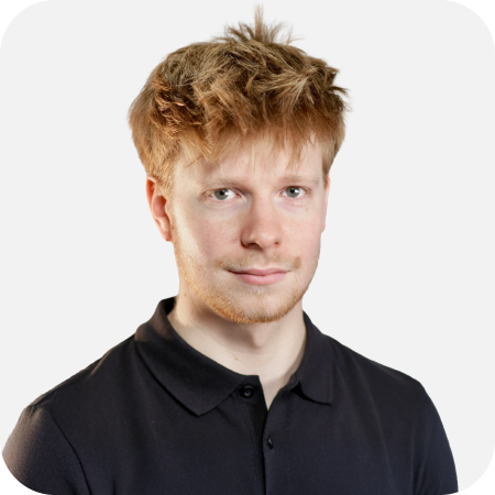 Professional team member wearing a black polo shirt, pictured against a light background.