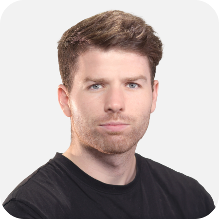 Professional headshot of a male IT team member wearing a black t-shirt against a clean white background.